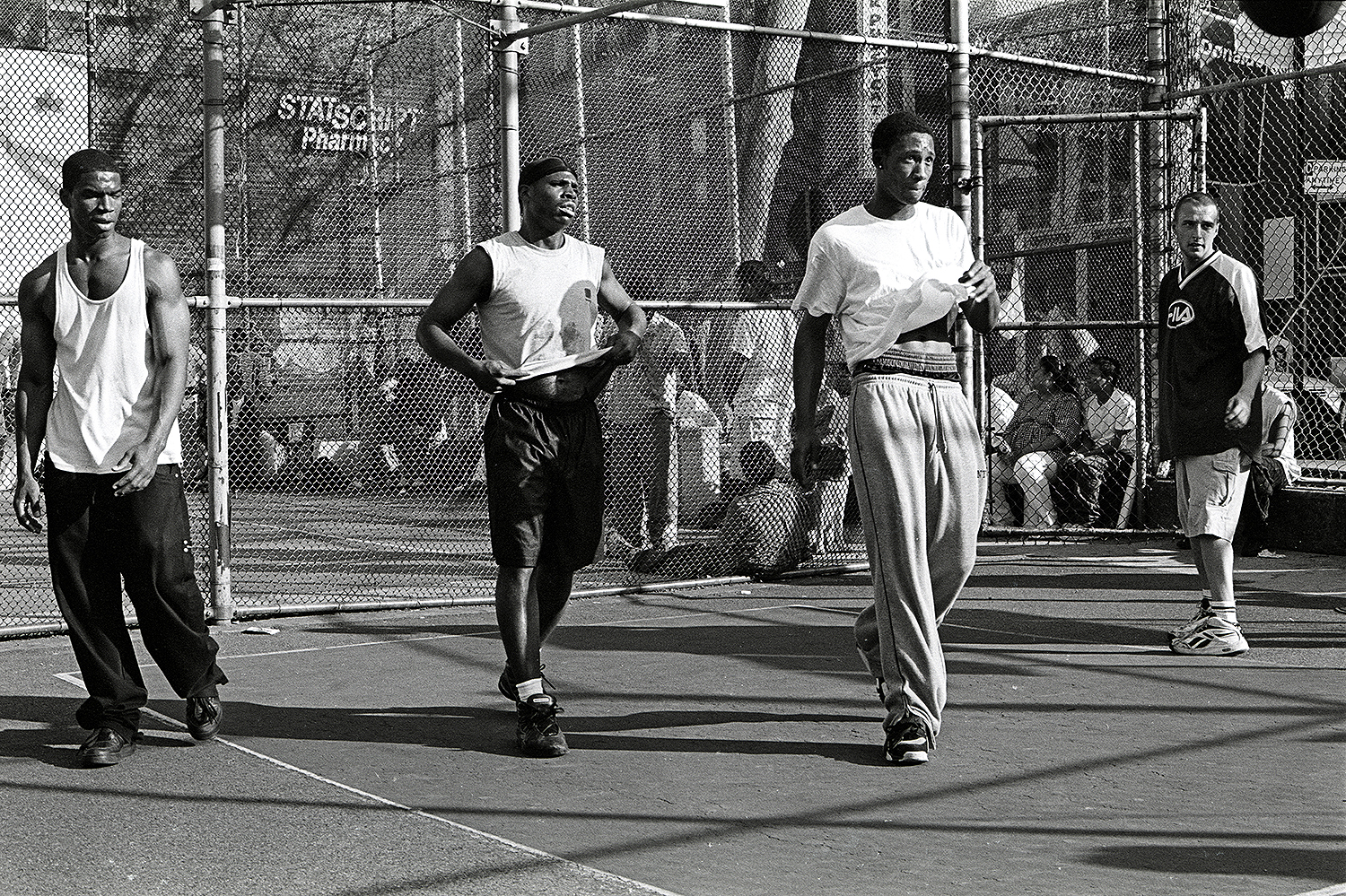 On the side court, or 'trash'court, everybody can play. The regulars, that generally play on the main court, sometimes go there to warm-up in  as are doing Mike (second from the left) and Rich (second from the right) . March 2002